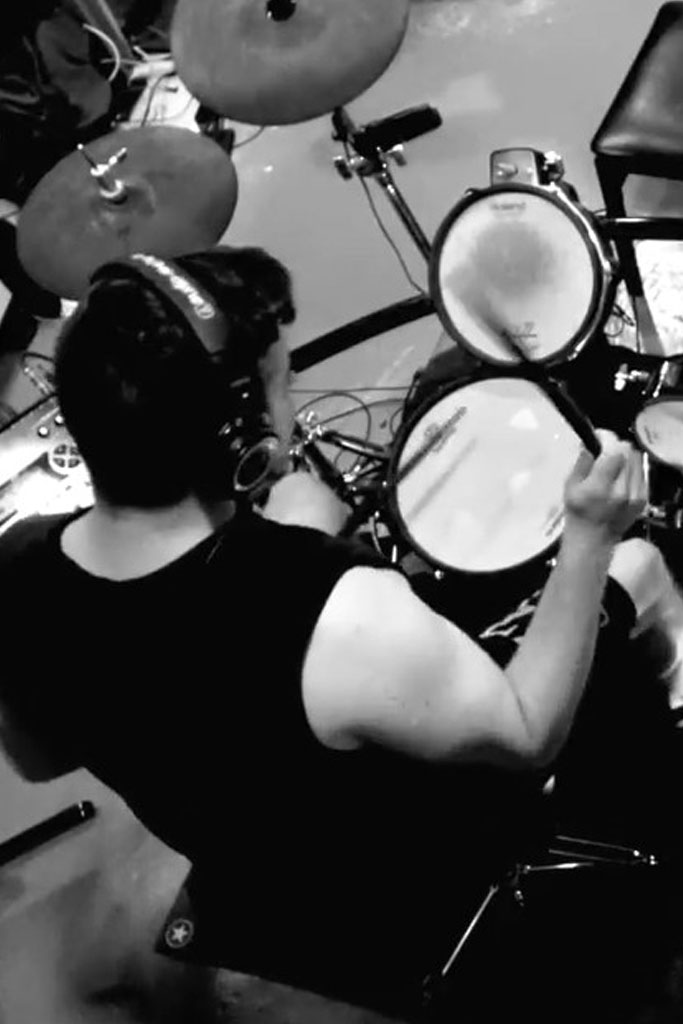 Image of John V. Kane playing drums.