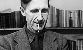 Close up photo of the author George Orwell using a typewriter.