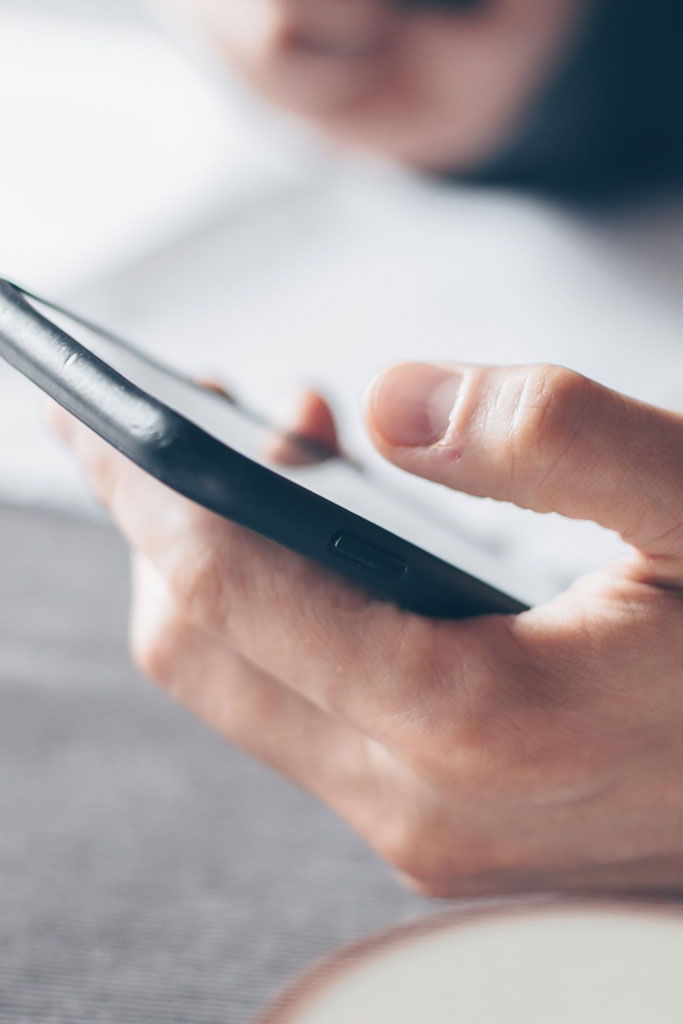 Photo of a hand holding a cell phone.