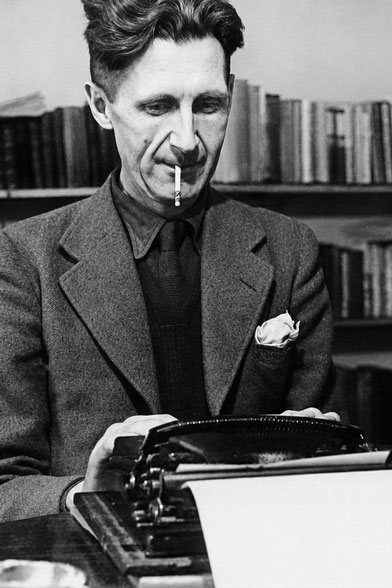 Photo of the author George Orwell using a typewriter.